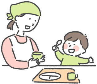 子どもが保育者に食事を食べさせてもらう様子