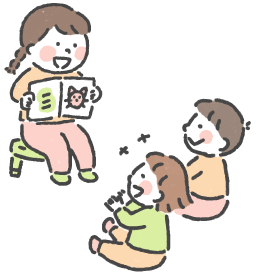 年次の高い子どもが年次の低い子どもに本を読み聞かせている様子